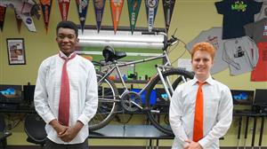Dandrell and Caleb pose with their invention after the Senior Design showcase