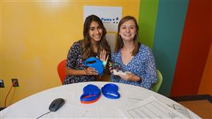 Raegan and Kaylee post with their invention